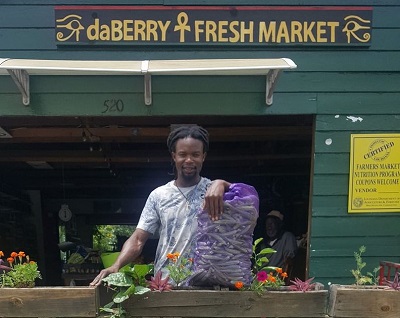 Carl Cooper Jr selling okra at Da Berry Fresh Market - Photo by  Da Berry Fresh Market