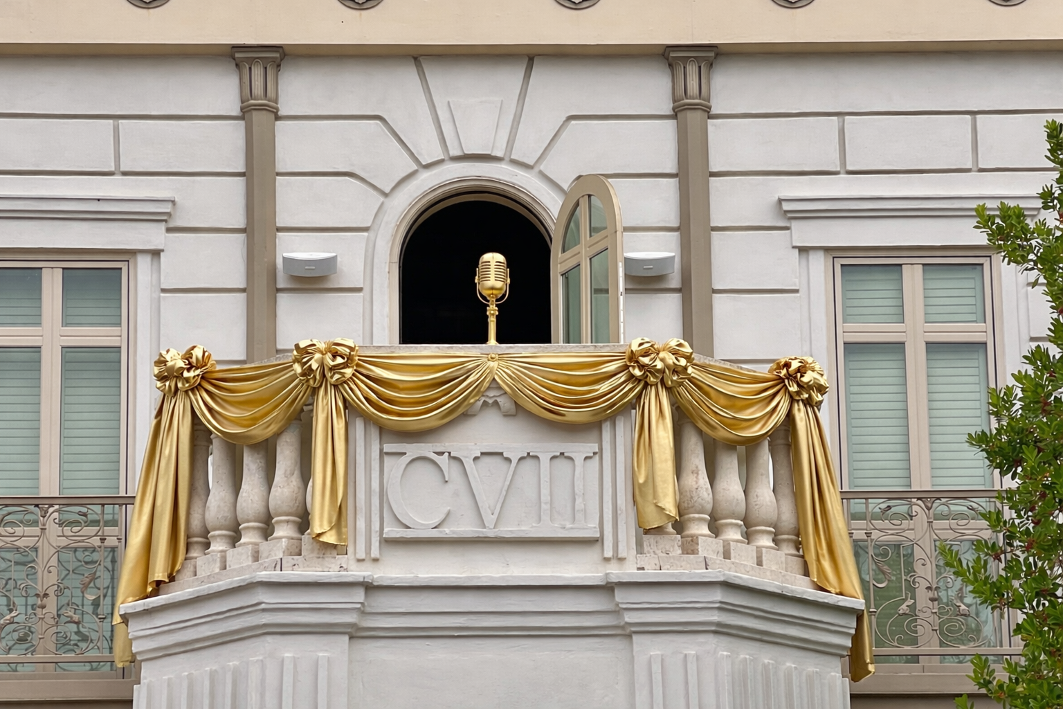 White balcony decorated with golden microphone and gold bunting for Golden Balcony talent show