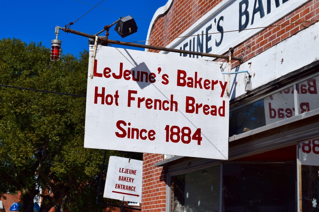 LeJeune's Bakery lettering on white sign hanging from front of store